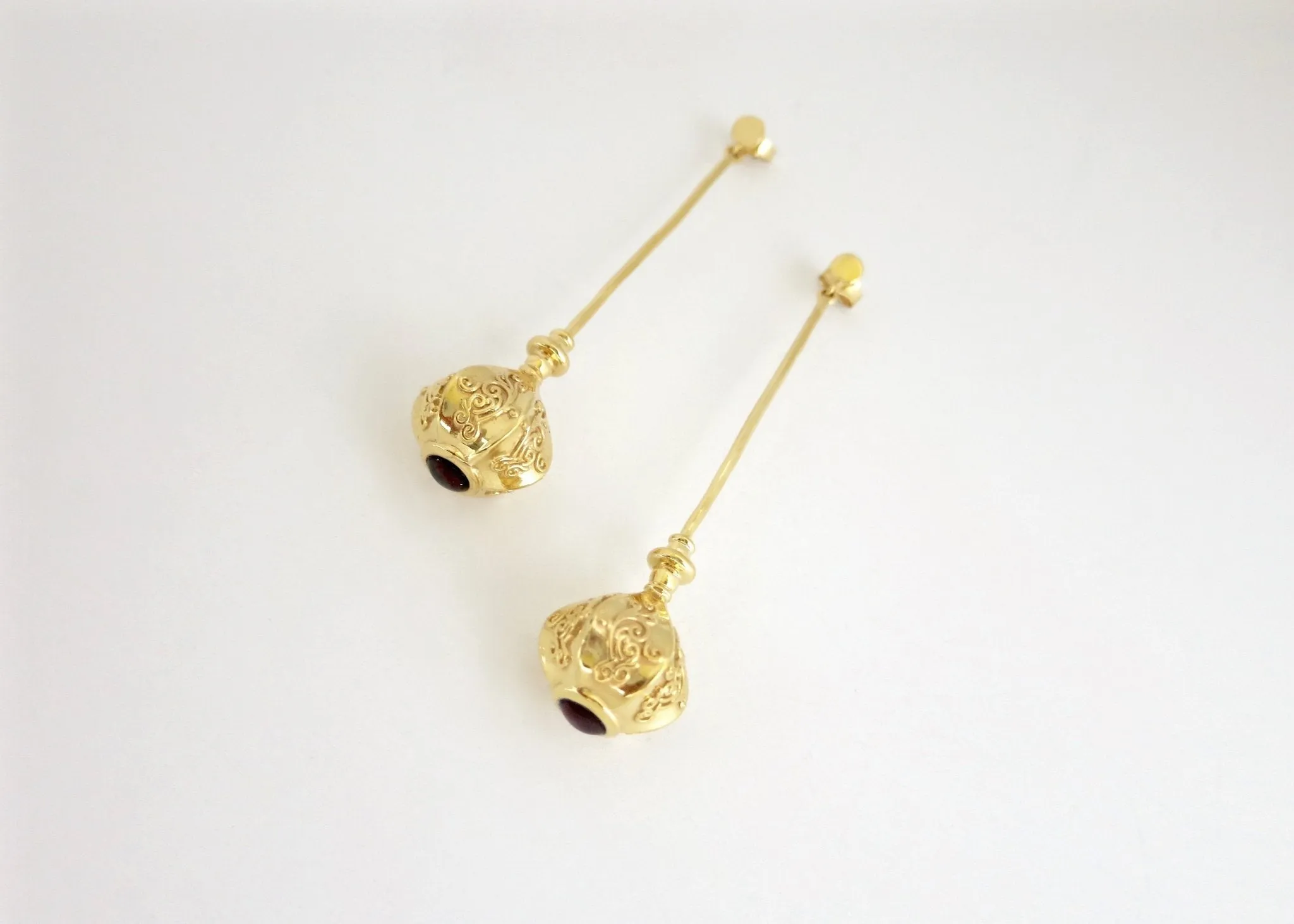 Elegant, stylish, gold plated long earrings with filigree work and garnet accent