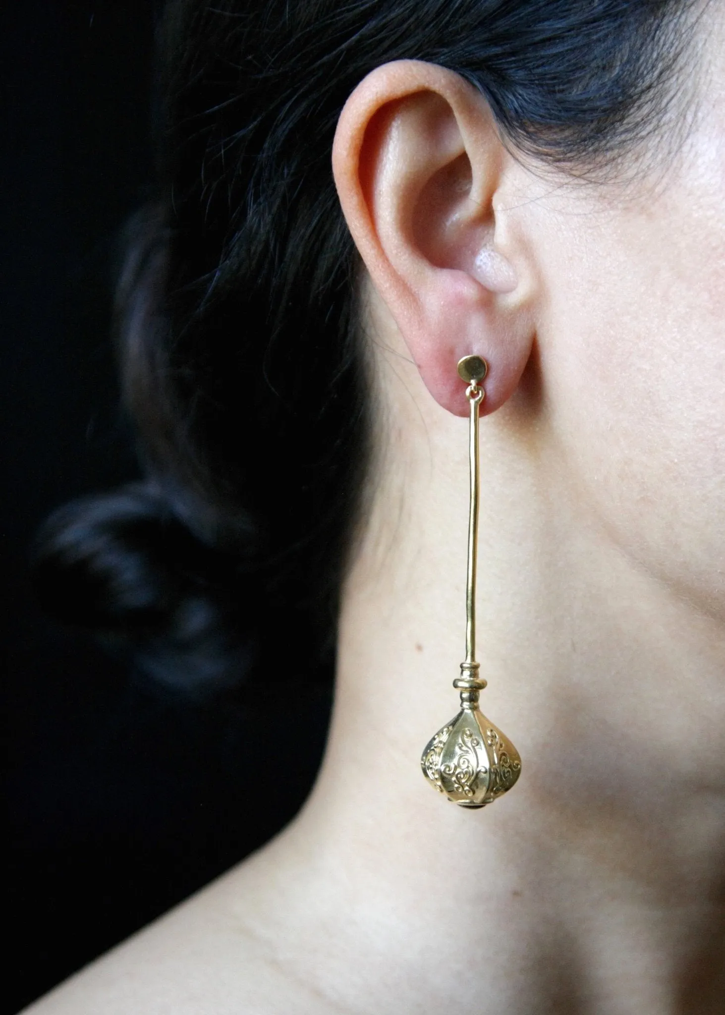 Elegant, stylish, gold plated long earrings with filigree work and garnet accent